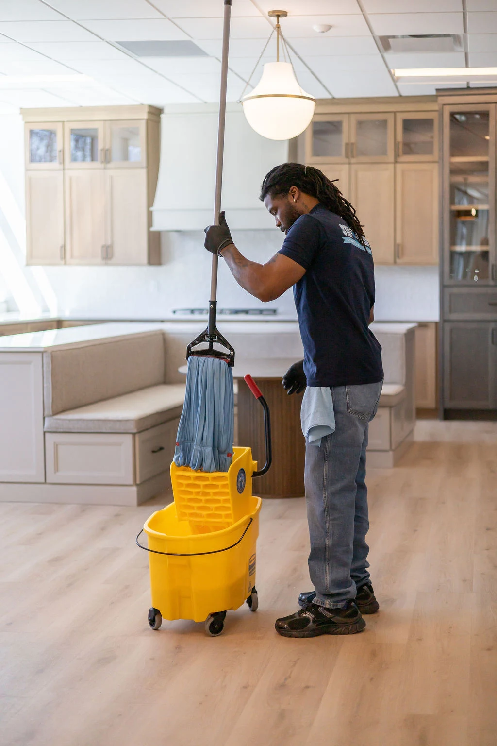 Technician mopping a large open commercial space