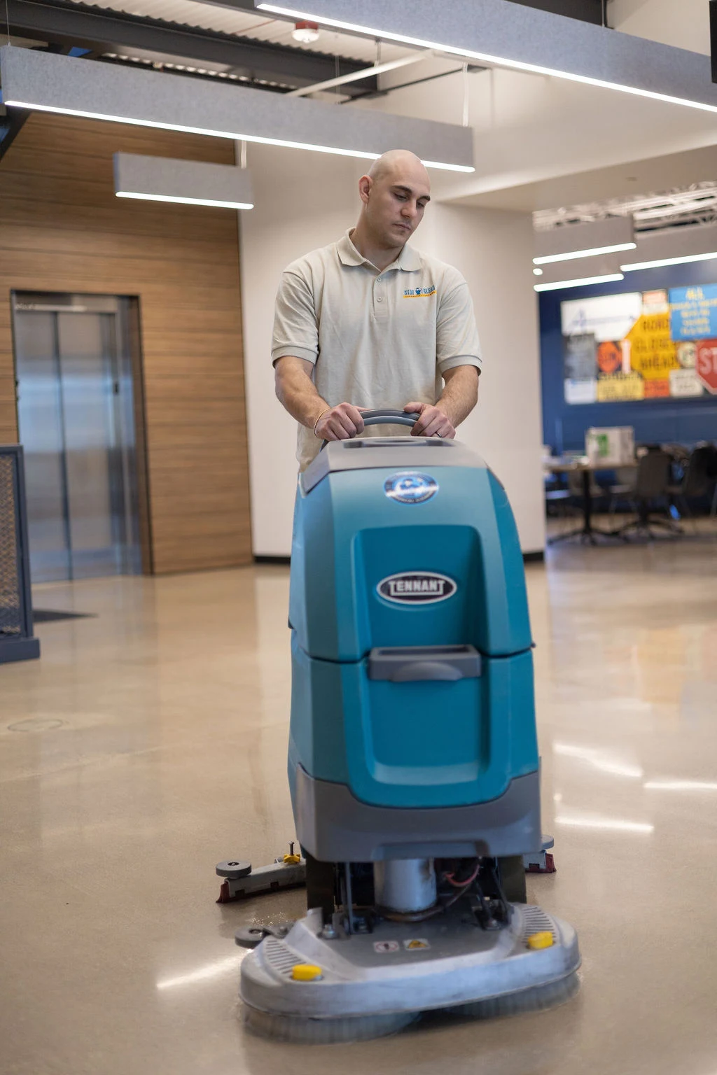 Stay Clean technician machine-polishing a stone lobby floor