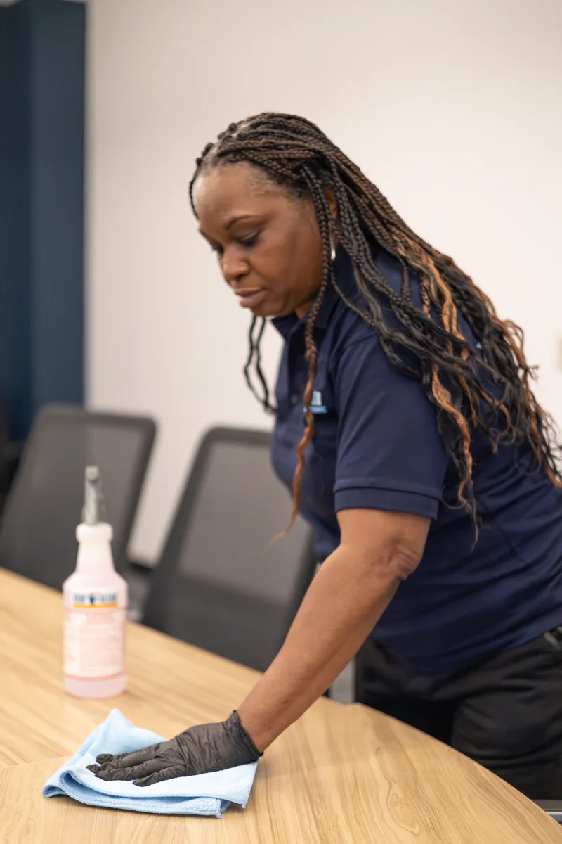 Stay Clean staff member detailing a conference room table